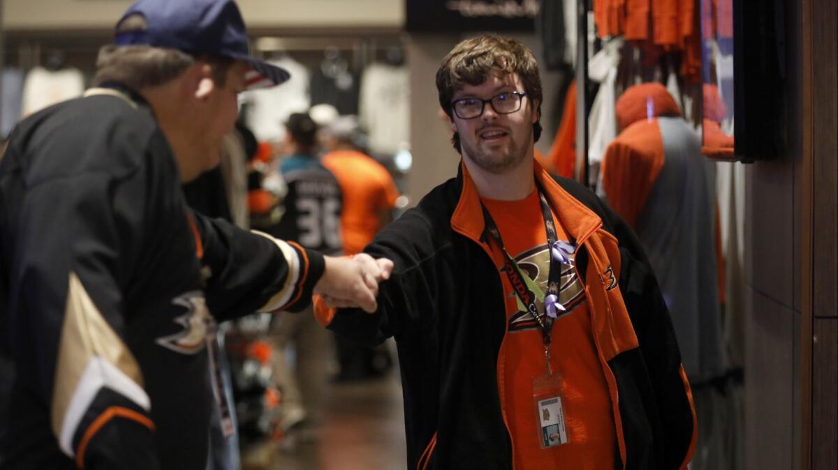 Trevor Hendershot, right, gives out so many fist-bumps that his knuckles sometimes become sore.