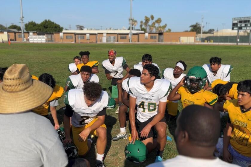 Jefferson High School kicker Oscar Silva (40) huddles with the team during practice on July 28, 2022.