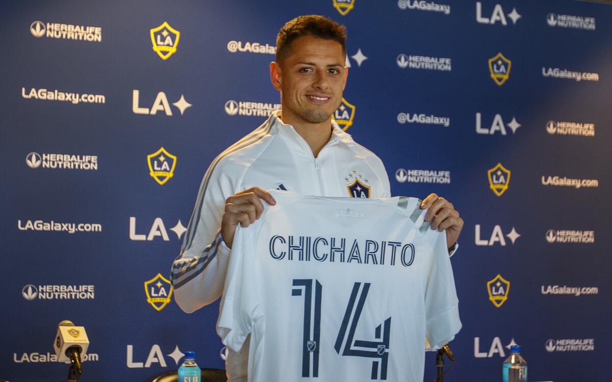 Javier "Chicharito" Hernandez holds up his new Galaxy jersey at a news conference Jan. 23, 2020, introducing him. 