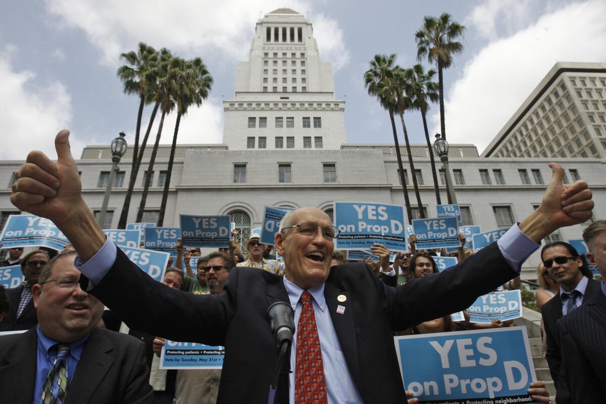 Former Los Angeles City Councilman Bill Rosendahl gives a thumbs up to supporters of Proposition D outside Los Angeles City Hall.