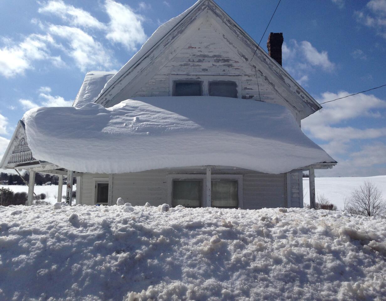 Heavy snow covers a roof near the village of Copenhagen, N.Y.