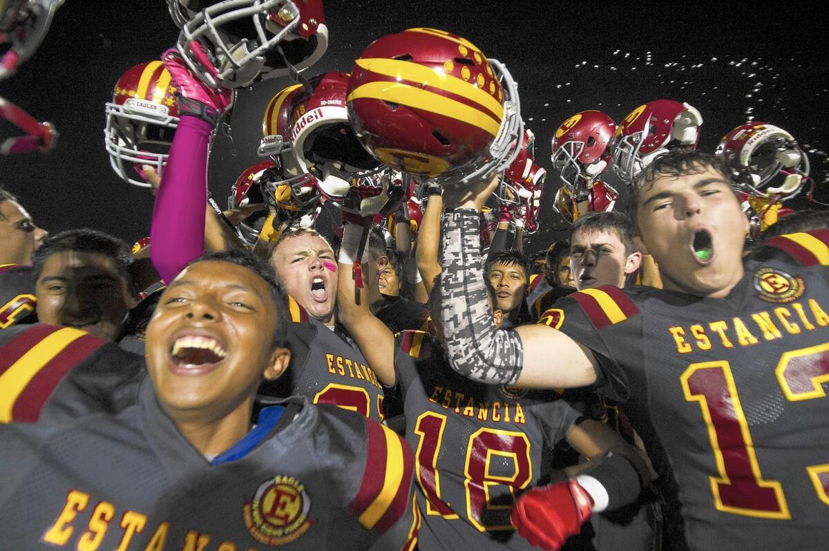 Estancia celebrates beating Costa Mesa, 23-0, in the Battle for the Bell on Friday.