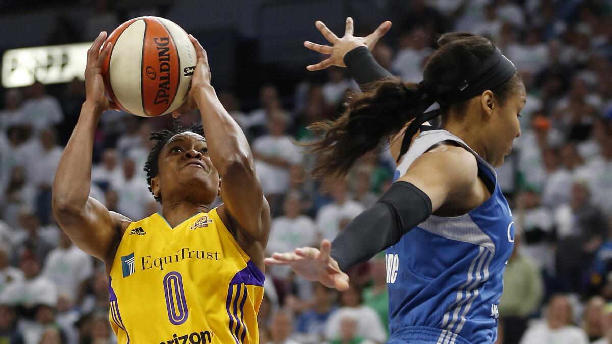 Sparks guard Alana Beard (0) floats past Lynx forward Maya Moore before putting up a shot in the first half of Game 1 on Sunday.