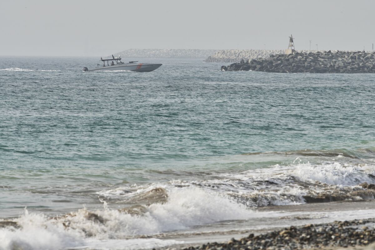An Emirati Coast Guard vessel patrols off Fujairah, United Arab Emirates, Wednesday, Aug. 4, 2021. The British navy warned of a "potential hijack" of another ship off the coast of the United Arab Emirates in the Gulf of Oman near Fujairah on Tuesday, though the circumstances remain unclear. (AP Photo/Jon Gambrell)