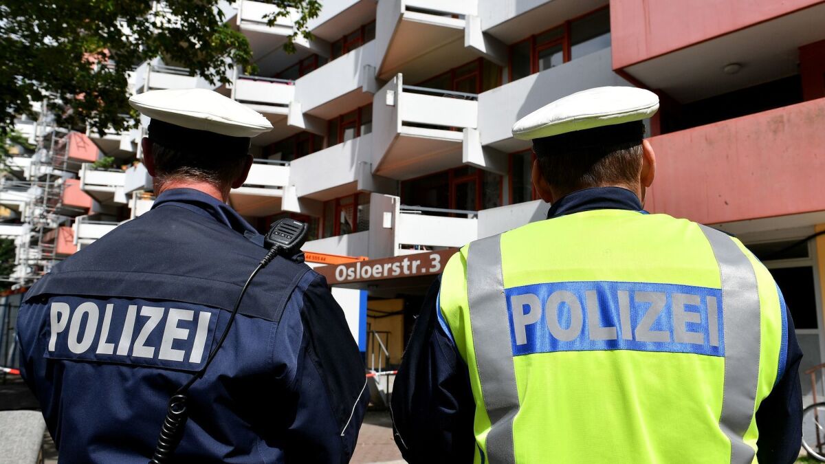 Police officers stand guard in front of an apartment block in the Chorweiler district of Cologne, Germany, on June 13. During a German special forces raid late on June 12, police found materials including ricin.