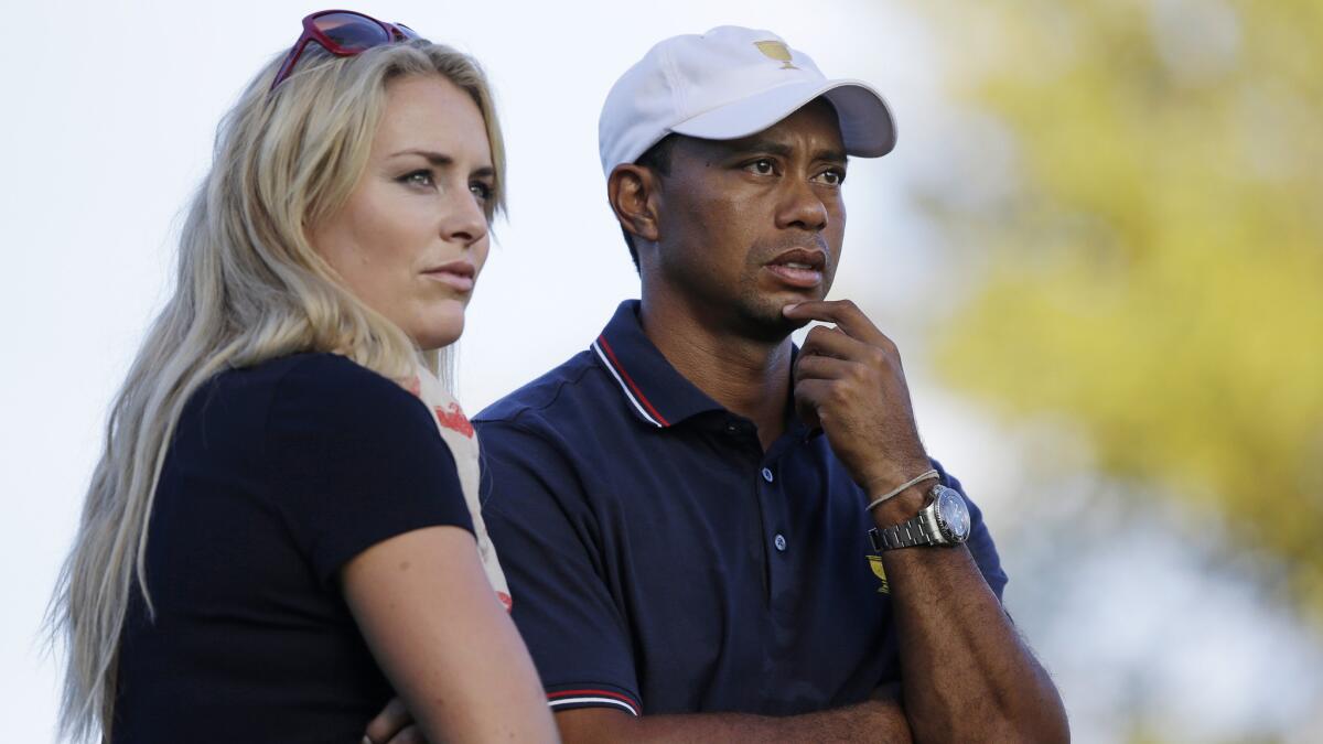 Tiger Woods stands next to his girlfriend, Olympic skier Lindsey Vonn, during the Presidents Cup tournament in Dublin, Ohio, on Oct. 3, 2013. After dating for nearly three years, Woods and Vonn announced their breakup on May 3, 2015.