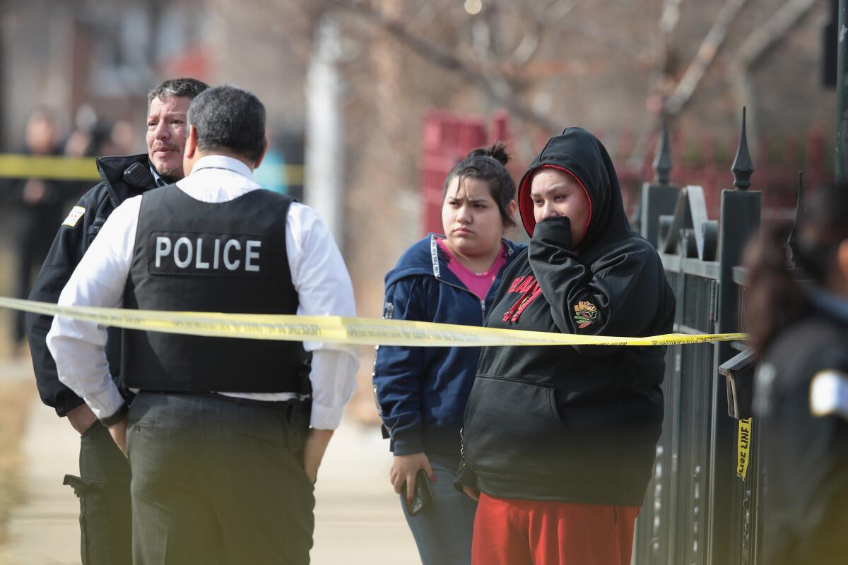 Police investigate the scene Feb. 6 after two people were discovered shot to death inside a Chicago apartment.