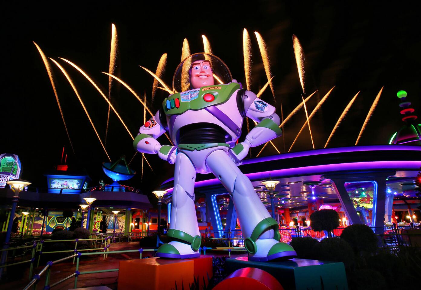 Fireworks launch behind Toy Story Land star Buzz Lightyear, during a first nighttime look at the new section of Disney's Hollywood Studios at Walt Disney World, in Lake Buena Vista, Fla., Thursday, June 28, 2018. (Joe Burbank/Orlando Sentinel) 3052311