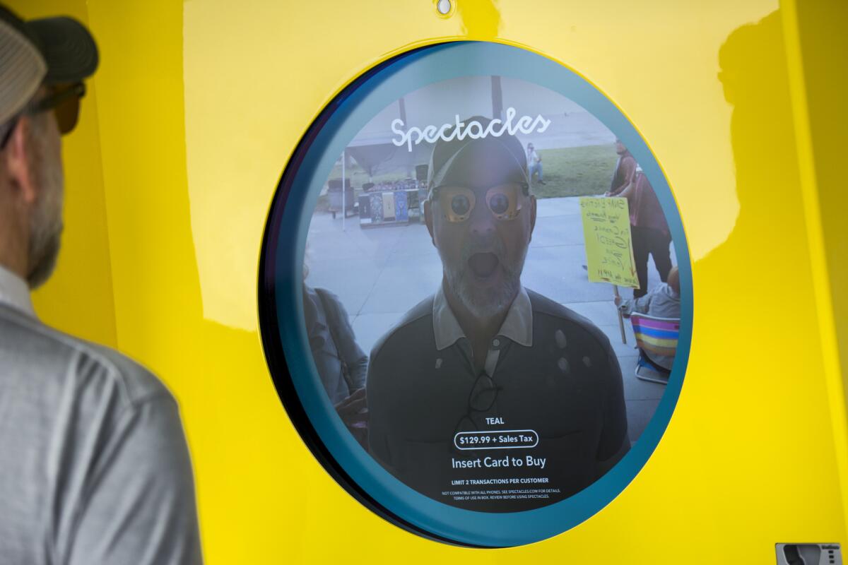 Passersby can stand in front of kiosks at the Snapchat Spectacles store and see themselves with the glasses projected onto their image, along Ocean Front Walk in Venice.