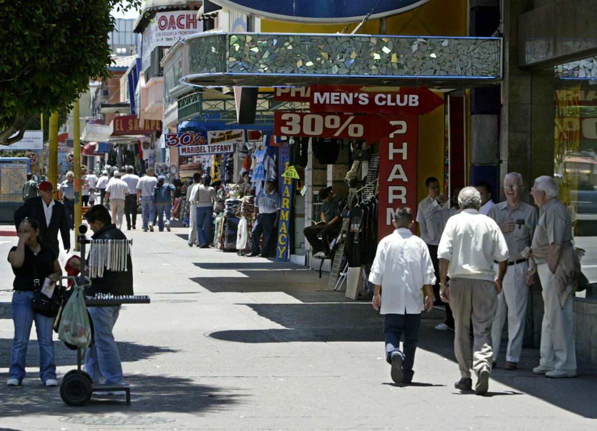 Shoppers and vendors mingle along the popular Avenida Revolución in Tijuana, Mexico.