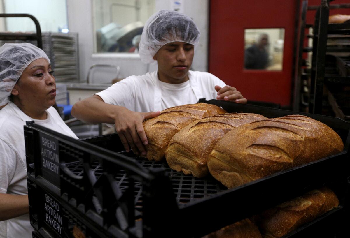 Fresh baked bread comes out of the ovens at the Bread Artisan Bakery in Santa Ana.