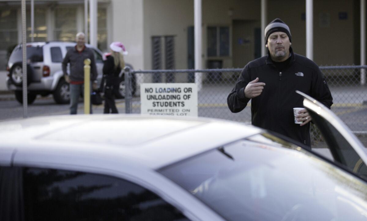 Hale Charter Academy principal Chris Perdigao instructs parents trying to drop kids off at the Woodland Hills campus on Dec. 15 that the school is closed.