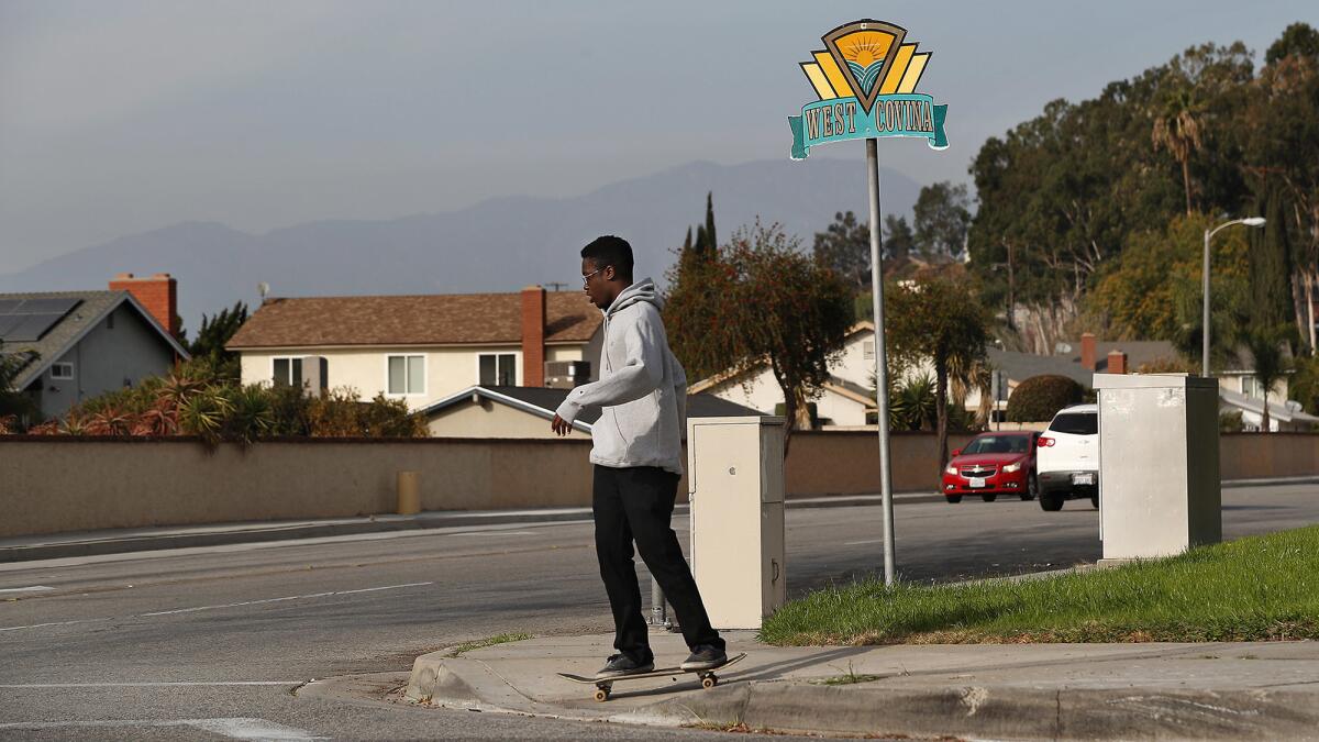 A skateboarder crosses the intersection at Lark Ellen Avenue and Amar Road.