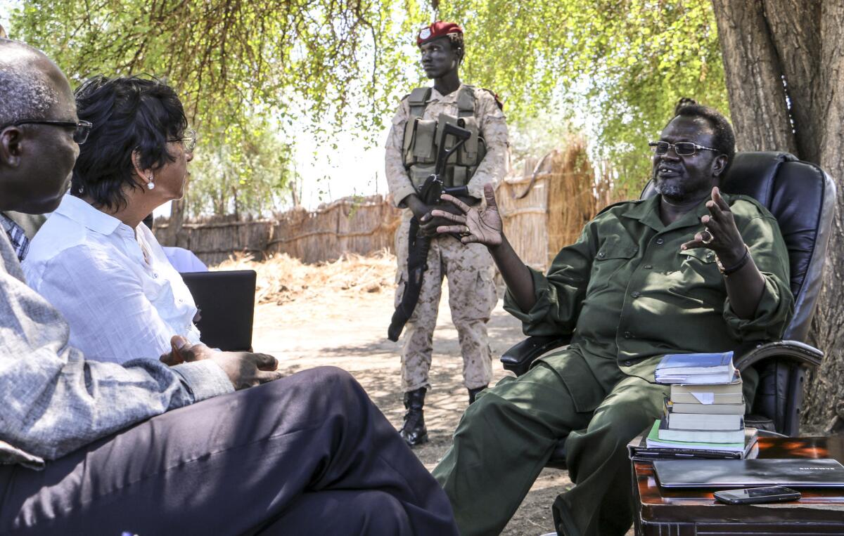 U.N. human rights chief Navi Pillay, second from the left, and genocide advisor Adama Dieng, left, meet with Riek Machar, South Sudan's former vice resident and now rebel leader, at an undisclosed location in South Sudan.