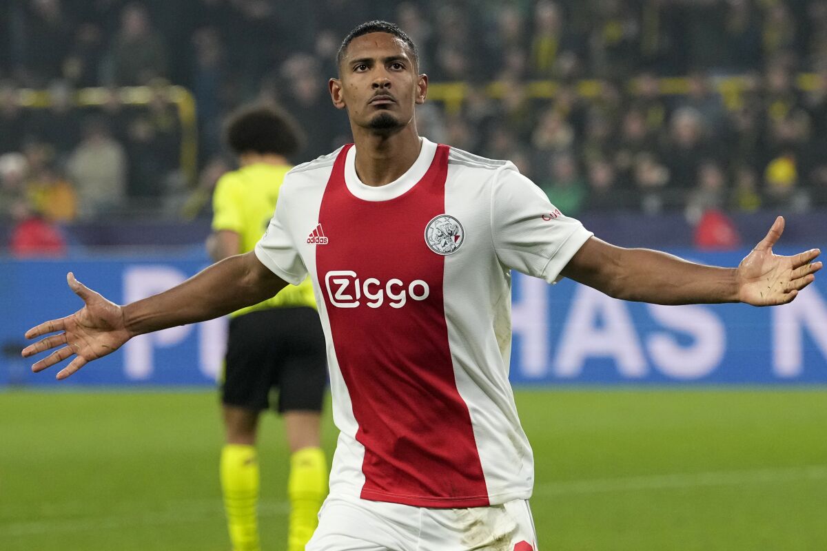 Ajax's Sebastien Haller celebrates after scoring his side's second goal during the Champions League group C soccer match between Borussia Dortmund and Ajax Amsterdam in Dortmund, Germany, Wednesday, Nov. 3, 2021. (AP Photo/Martin Meissner)