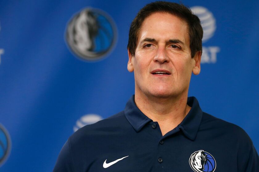 Dallas Mavericks owner Mark Cuban stands on stage before Cynthia Marshall, new interim CEO of the team, is introduced during a news conference, Monday, Feb. 26, 2018, in Dallas. Cuban has teased about the notion of running for president in 2020 in a campaign that could mirror President Donald Trumpâs blend of reality TV and politics. But Cuban's political career could be quickly derailed by sexual harassment and misconduct allegations within his team. (AP Photo/Ron Jenkins)