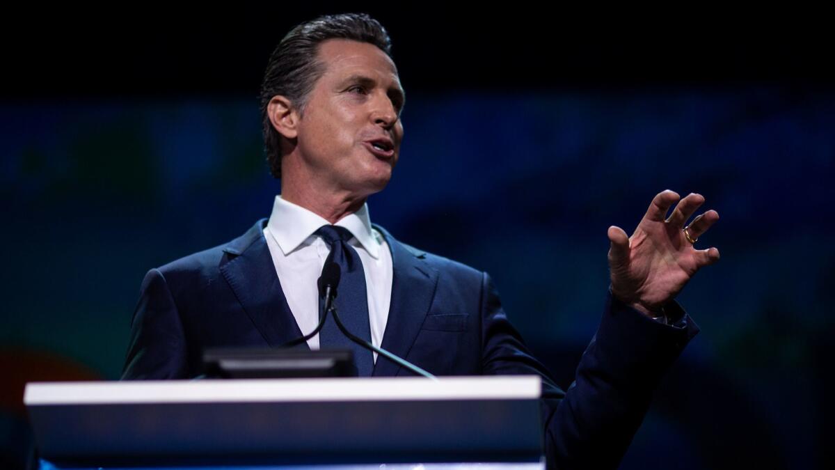 Gov. Gavin Newsom addresses delegates at the California State Democratic Party convention at the Moscone Center on Saturday in San Francisco.