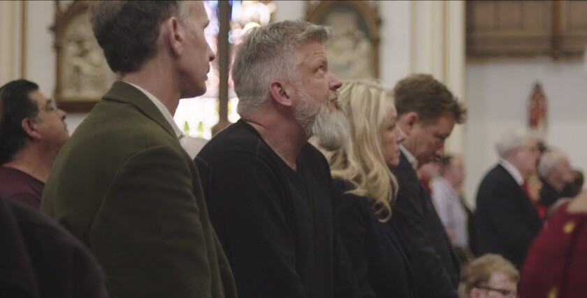 This image released by Netflix shows Michael Sandridge, foreground left, and Dan Laurine, center, in a scene from the documentary "Procession." (Netflix via AP)