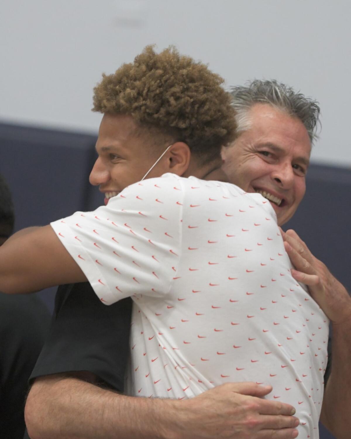 Etiwanda basketball coach Dave Kleckner hugs NBA player Kessler Edwards.