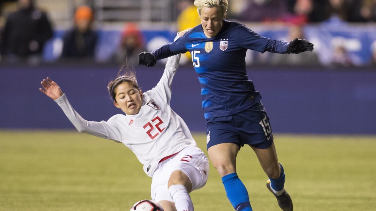 United States' Megan Rapinoe, right, tries to get around Japan's Risa Shimizu with the ball during the first half of SheBelieves Cup on Wednesday in Chester, Pa.