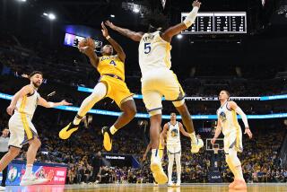 San Francisco, California May 10, 2023-Lakers Lonnie Walker scores a basket over Warriors Kevon Looney in the second half in Game 5 of the NBA playoff series at Chase Center Wednesday. (Wally Skalij/Los Angeles Times)