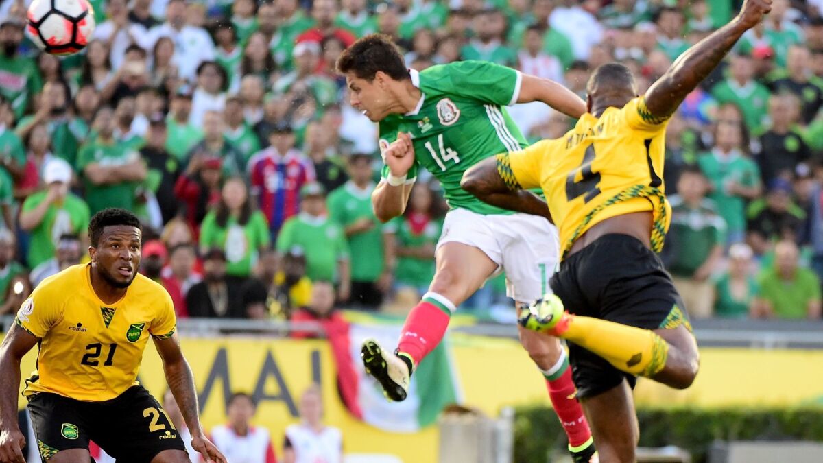 Chicharito scores for Mexico on a header between between Jamaica's Wes Morgan (4) and Jermaine Taylor on June 9, 2016, at the Rose Bowl.