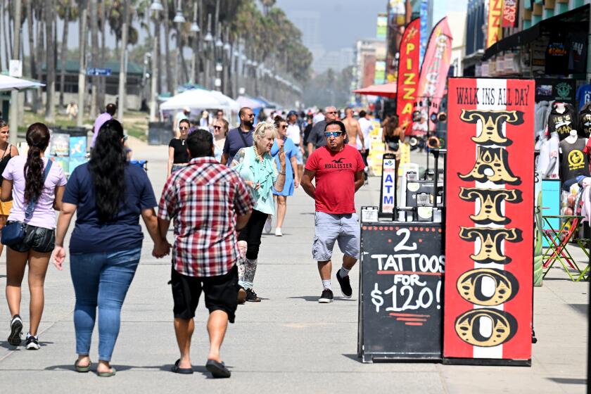 Venice, California August 31, 2023-People walk along the Venice Boardwalk as COVID-19 makes a comeback in California Thursday. (Wally Skalij/Los Angles Times)