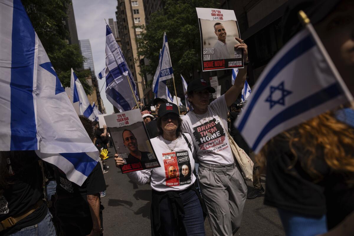 Parade-goers hold Israeli flags in New York.