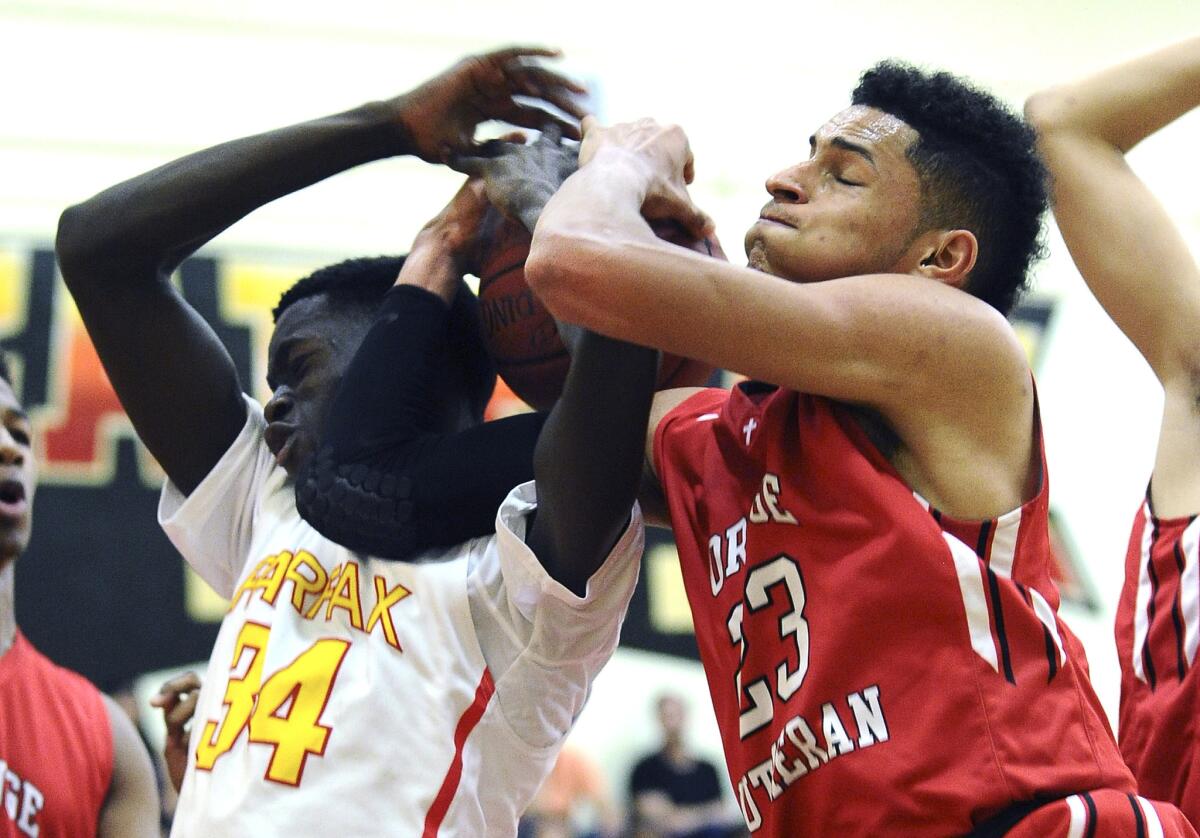 Fairfax's Babacar Thiombane and Orange Lutheran's Rogers Printup battle for a rebound during their playoff game.