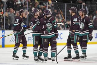 The Ducks celebrate the team's win over the Ottawa Senators Wednesday in Anaheim