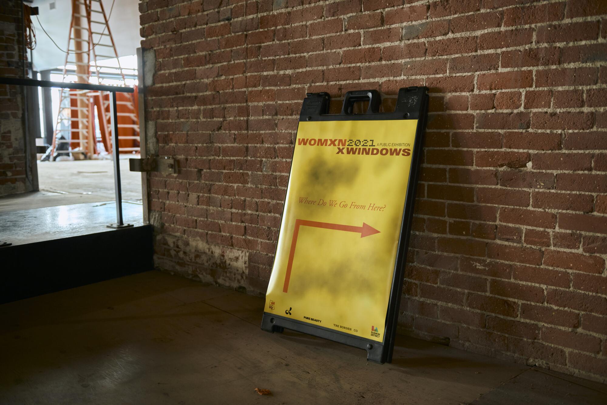 A sign for Womxn in Windows in the building of the exhibition, curated by Zehra Ahmed.