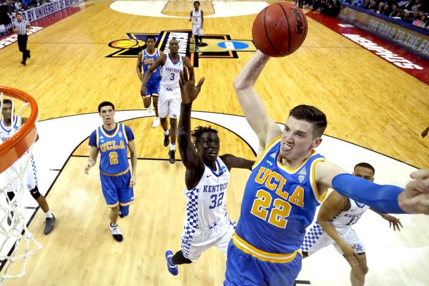 UCLA forward TJ Leaf takes off for a dunk against Kentucky during the first half Friday.