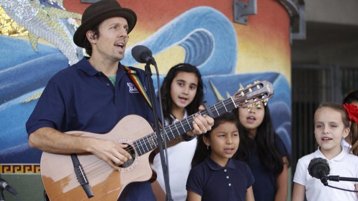 Jason Mraz is shown singing in 2014 with students at Oceanside's Burbank Elementary School.