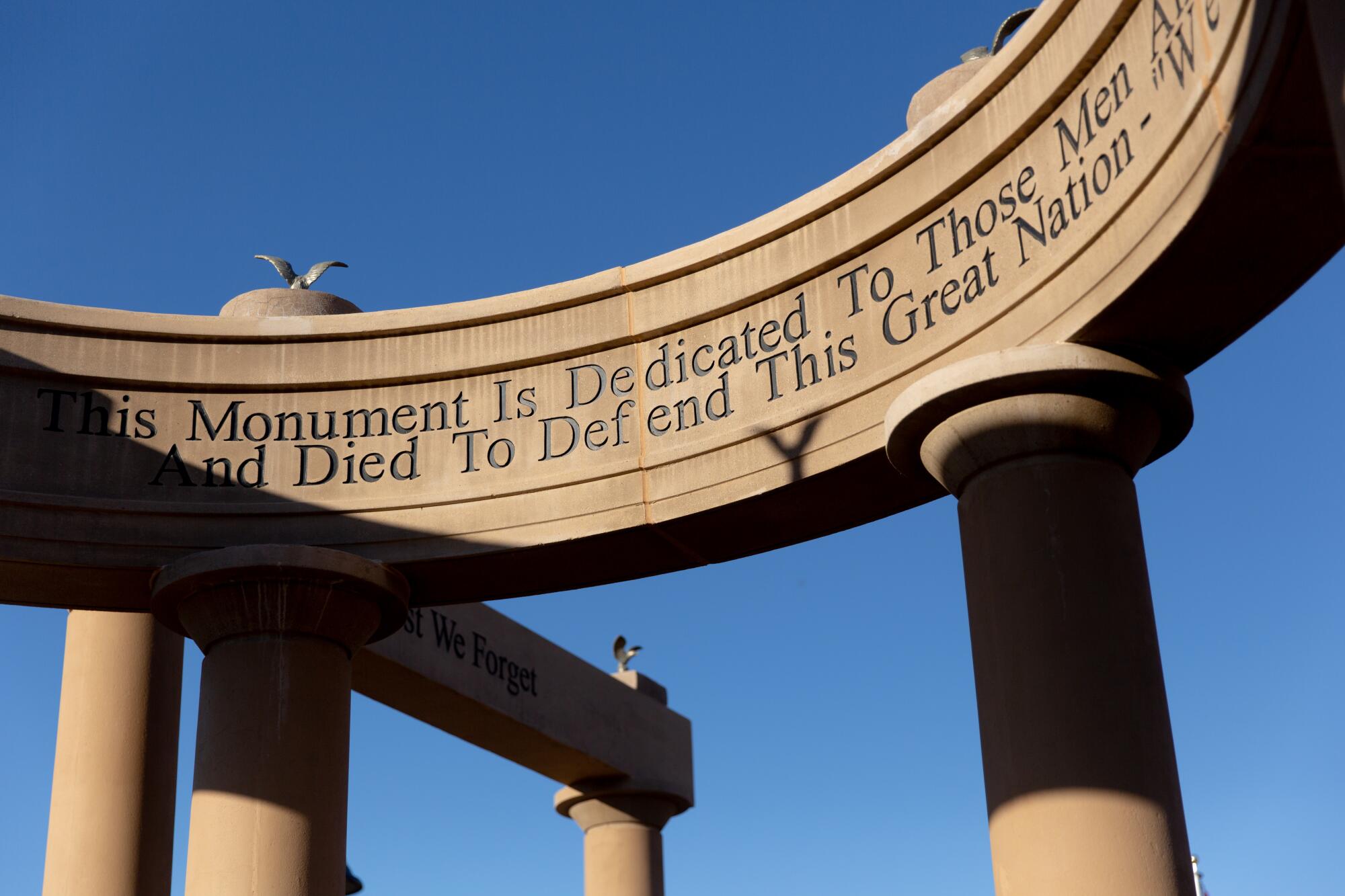 A monument with columns and and inscription about military members who were killed