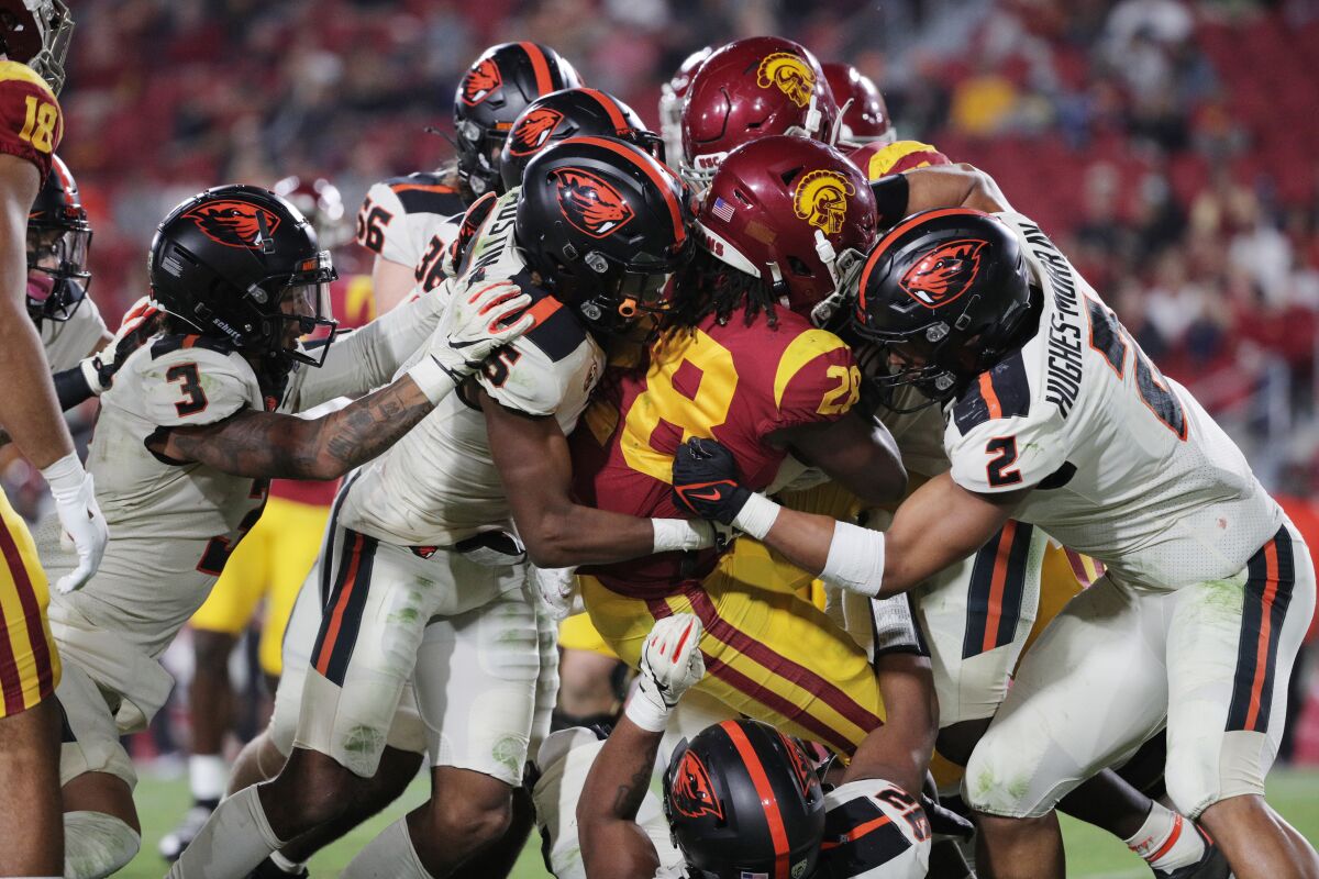 USC running back Keaontay Ingram is brought down by the Oregon State defense.