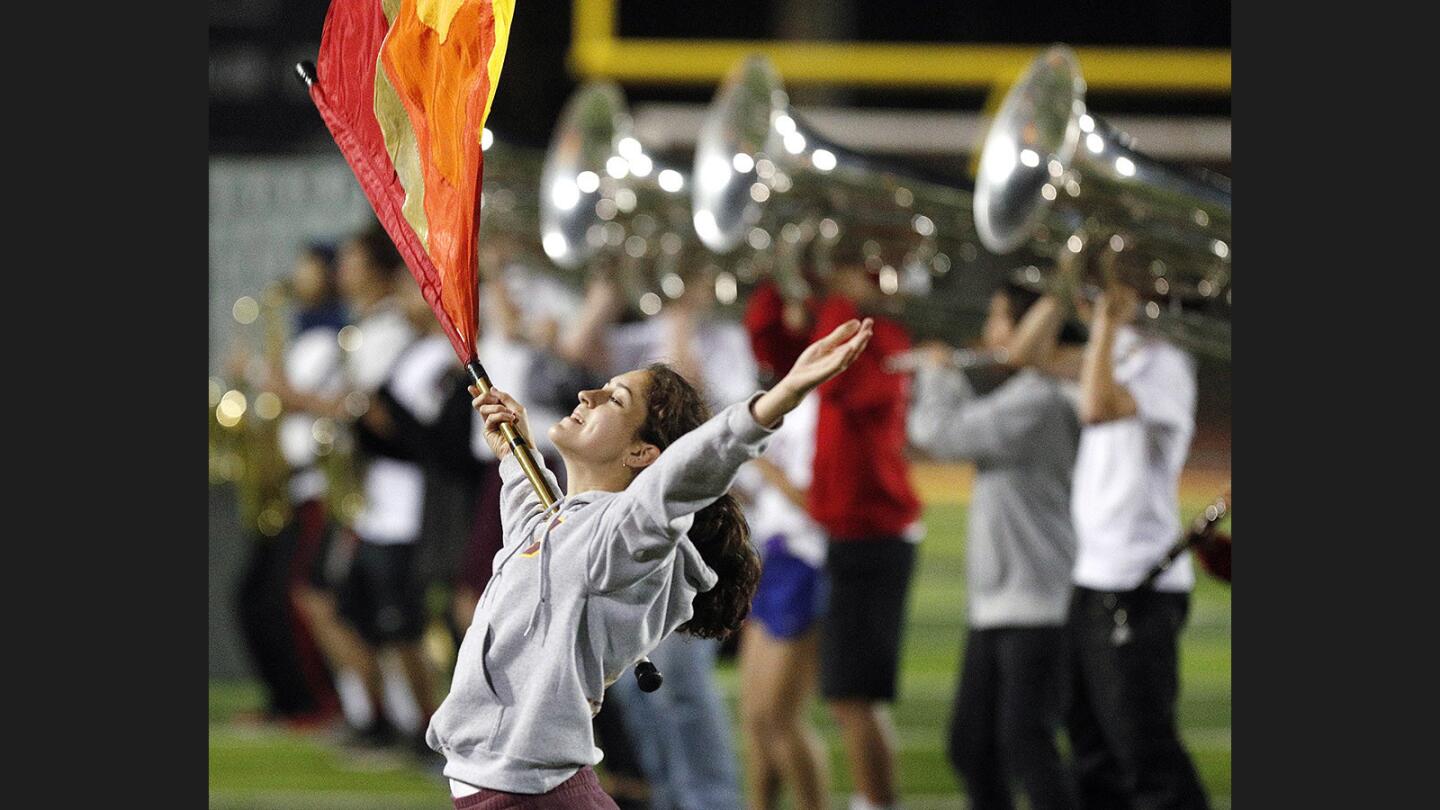 Maddy Mertens, 17, of the La Canada High School Marching Band and Color Guard at a last-week rehearsal of their field show "Rapunzel" on Tuesday, November 14, 2017. The band will perform a friends and family show this Friday before traveling to Fresno for the Western Band Assn.'s Class Championships this Saturday.