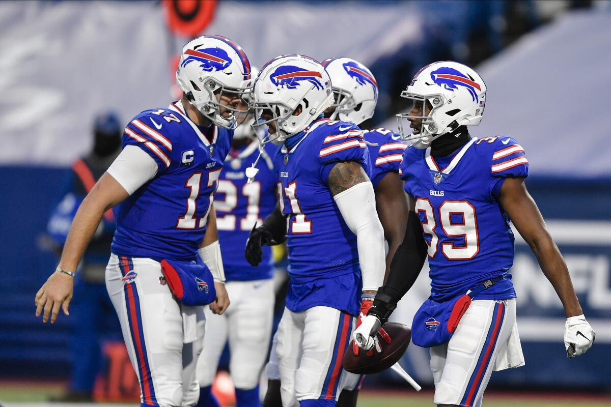 Buffalo Bills quarterback Josh Allen and Levi Wallace celebrate with Dean Marlowe.