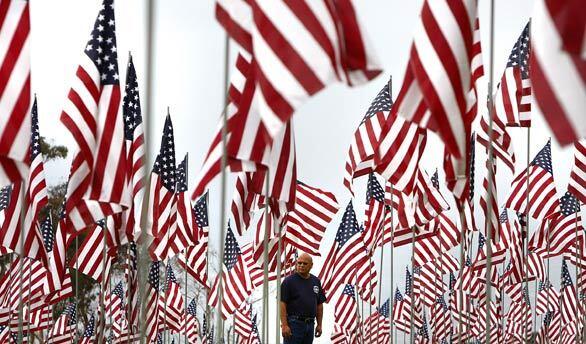 Fidel Olmos of Los Angeles strolls among nearly 3,000 flags, one for every victim of the 9/11 attacks, on a Malibu hillside at Pepperdine University in observance of Sept. 11.