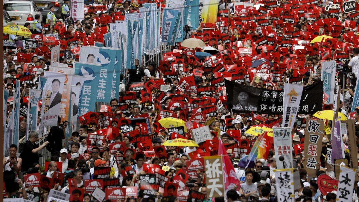 Protesters march along a downtown street against the proposed amendments to an extradition law in Hong Kong on June 9, 2019.