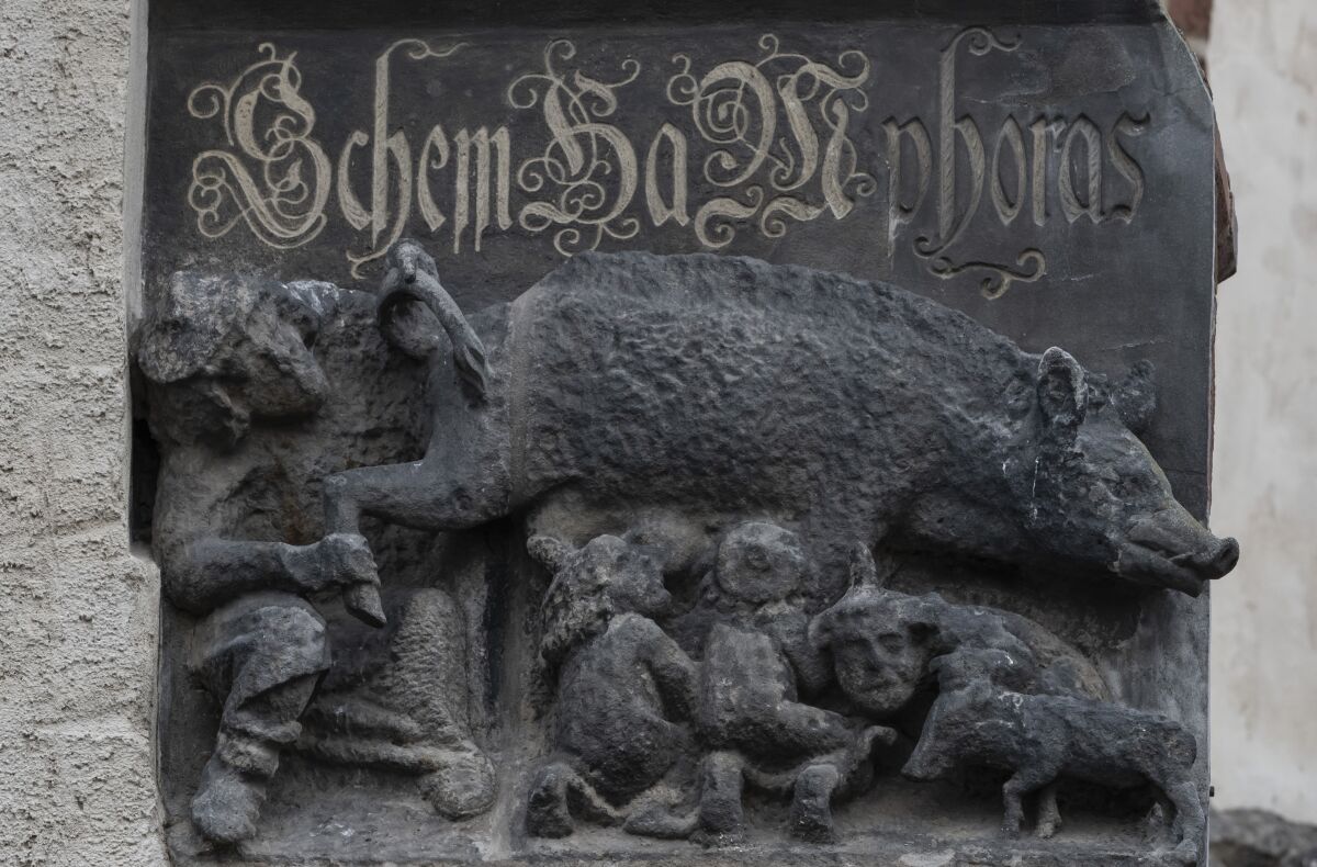 File - The so-called 'Judensau' or 'Jew pig' sculpture is pictured on the facade of the Stadtkirche, Town Church, in Wittenberg, Germany, Jan. 14, 2020. The sculpture is located about 4 meters, 13 feet, above the ground. A German federal court will decide on a Jewish man's bid to force the removal of the 700-year-old antisemitic statue from the church, where Martin Luther once preached. (AP Photo/Jens Meyer, File)