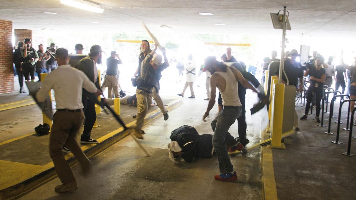 DeAndre Harris, bottom, is assailed in a parking garage beside the Charlottesville police station after a white nationalist rally was dispersed by police on Aug. 12, 2017.