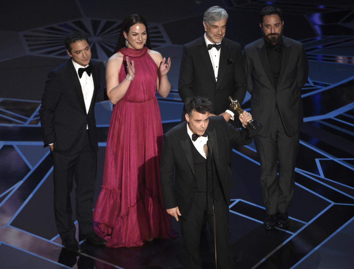 "A Fantastic Woman" director Sebastian Lelio, foreground center, with, from back left, Nicolas Saavedra, Daniela Vega, Alejandro Goic, and Pablo Larrain, accepting the Oscar for foreign language film at the 90th Academy Awards.