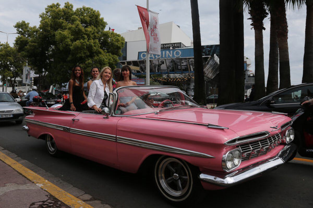 Women ride on La Croisette in a pink vintage Chevrolet Impala hours before the opening of the 66th Cannes Film Festival on Wednesday.