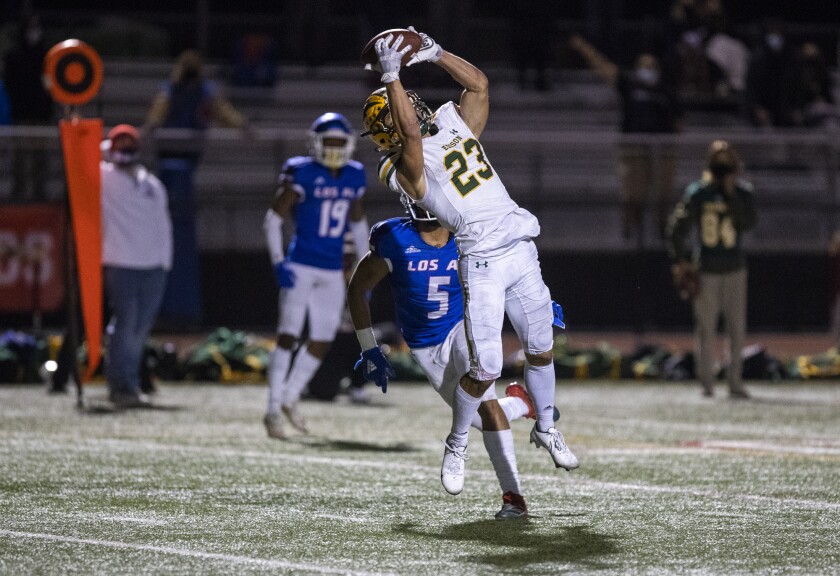 Edison's Nico Brown makes a catch over Los Alamitos' Lane Broderick for a touchdown during a Sunset League game on March 26.