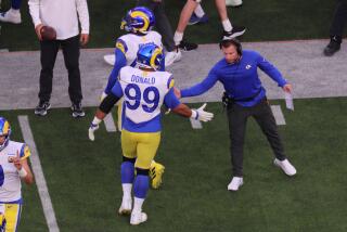 Rams coach Sean McVay congratulates  Aaron Donald (99) during Super Bowl LVI at SoFi Stadium.