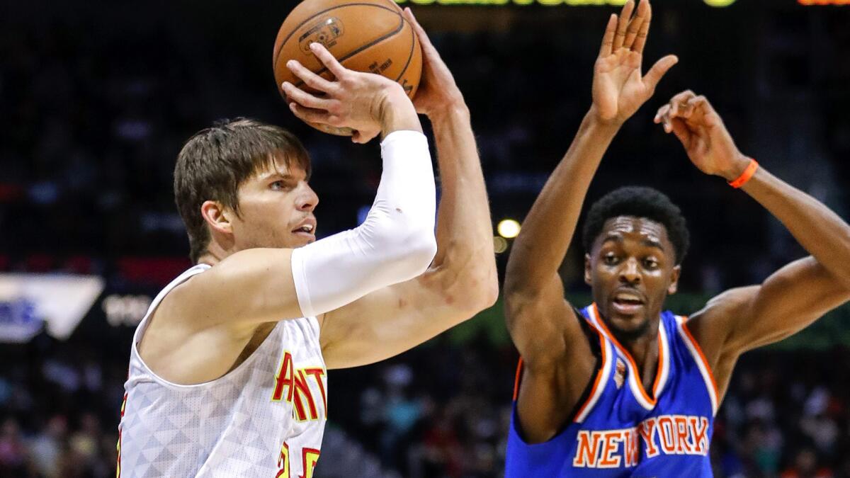 Hawks guard Kyle Korver lines up a shot as Knicks guard Justin Holiday arrives late on the close out during a game Dec. 28.