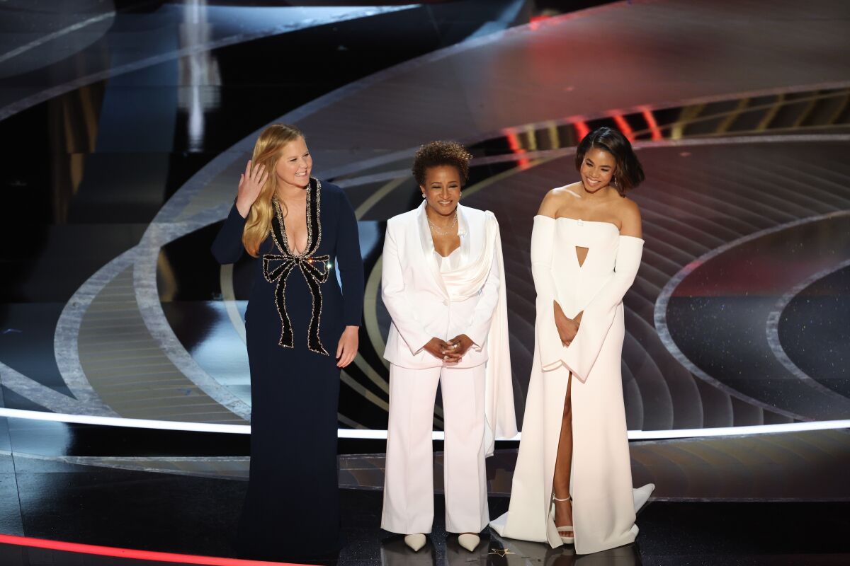 Amy Schumer, Wanda Sykes and Regina Hall onstage at the 2022 Oscars.