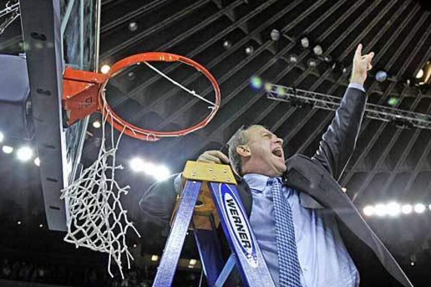 VICTORY: Bruins head coach Ben Howland lets out a scream for the fans before he finishes cutting down the net after beating the Memphis Tigers 50-45.