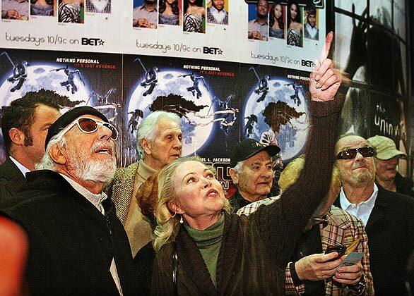 The late Elmer Valentine, co-founder of Whisky A Go-Go, was remembered by friends and fans who gathered Jan. 26 at the rock club he put so much heart into. Outside, the unveiling of street sign bearing his name was witnessed by business partner Lou Adler, left, Michelle Phillips of the Mamas & the Papas and actor friend Jack Nicholson.