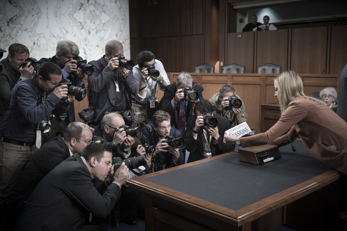 June 13, 2017 Photographers crowd the desk as a Senate staffer places a name card for Attorney General Jeff Sessions shortly before his testimony before the Senate Intelligence Committee about his meetings with President Donald Trump. Photo by David Butow